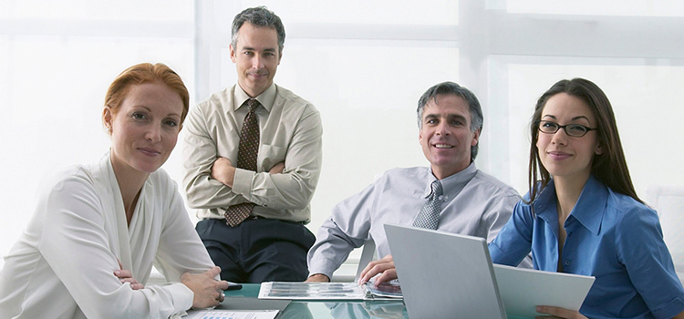 Business workers sitting around a meeting table.